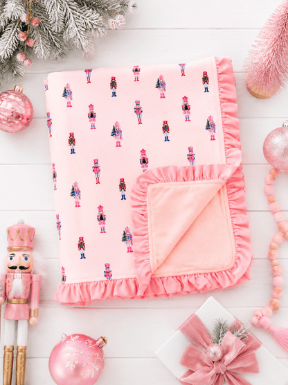 Pink Nutcracker Christmas ruffle minky baby blanket with plush blush backing and elegant ruffle trim detail.