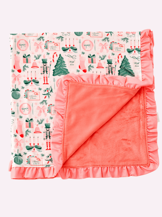 Christmas baby blanket with trees, nutcrackers, bows and lt pink ruffle trim
