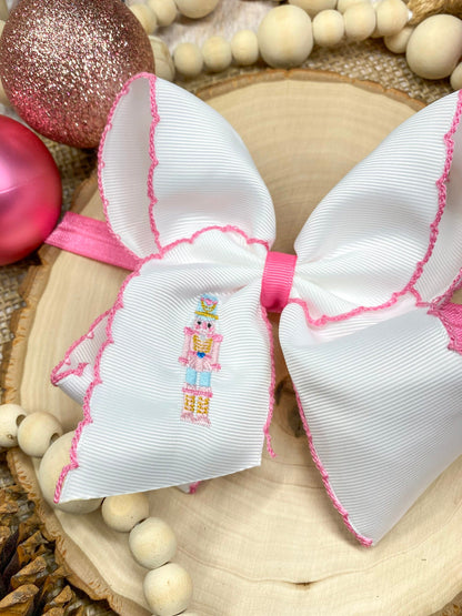 Pink Nutcracker Embroidered Moonstitch Headband on a wooden background