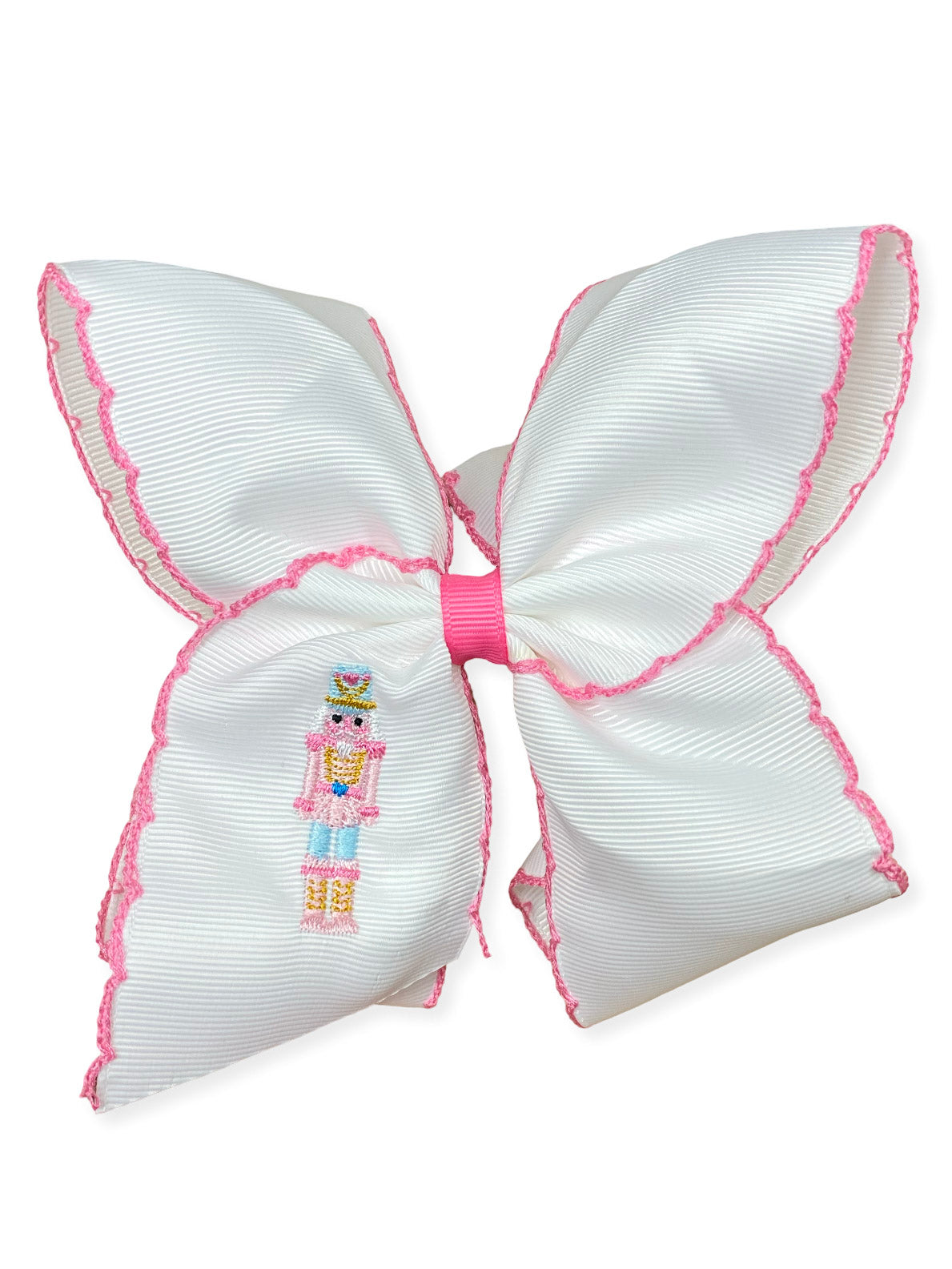Pink nutcracker embroidered moonstitch hair bow on a white background