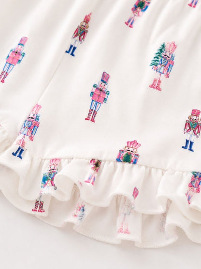 Close-up of Pink Nutcracker Christmas Mommy & Me pajamas with pastel nutcracker print, soft fabric, and ruffle shorts.