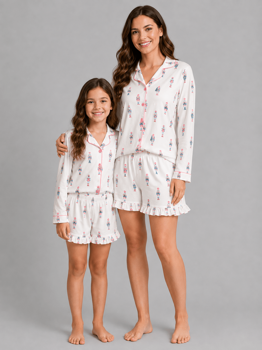 Pink Nutcracker Christmas Mommy & Me matching pajamas with pastel nutcracker print in a festive holiday flatlay.