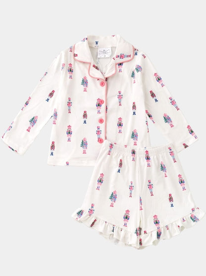 Girls Pink Nutcracker Christmas pajama set featuring a pastel nutcracker print, button-front top, and ruffle shorts.