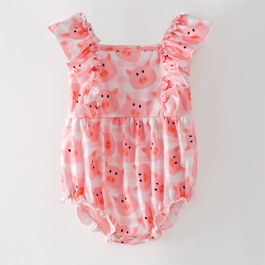 Pink romper with pig pattern on a white background