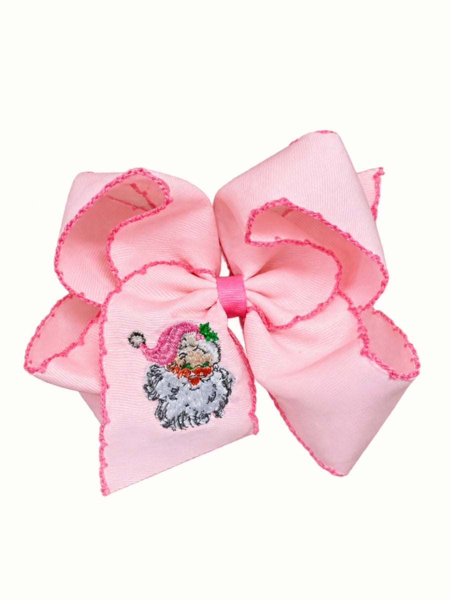 Light pink moonstitch hair bow with hot pink stitched edges and an embroidered vintage Santa in a pink hat on the tail, on a white background
