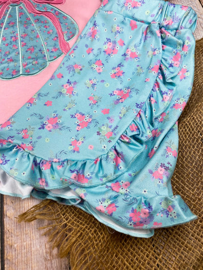 Girls sea shell outfit with pink top and blue shorts on a wooden background