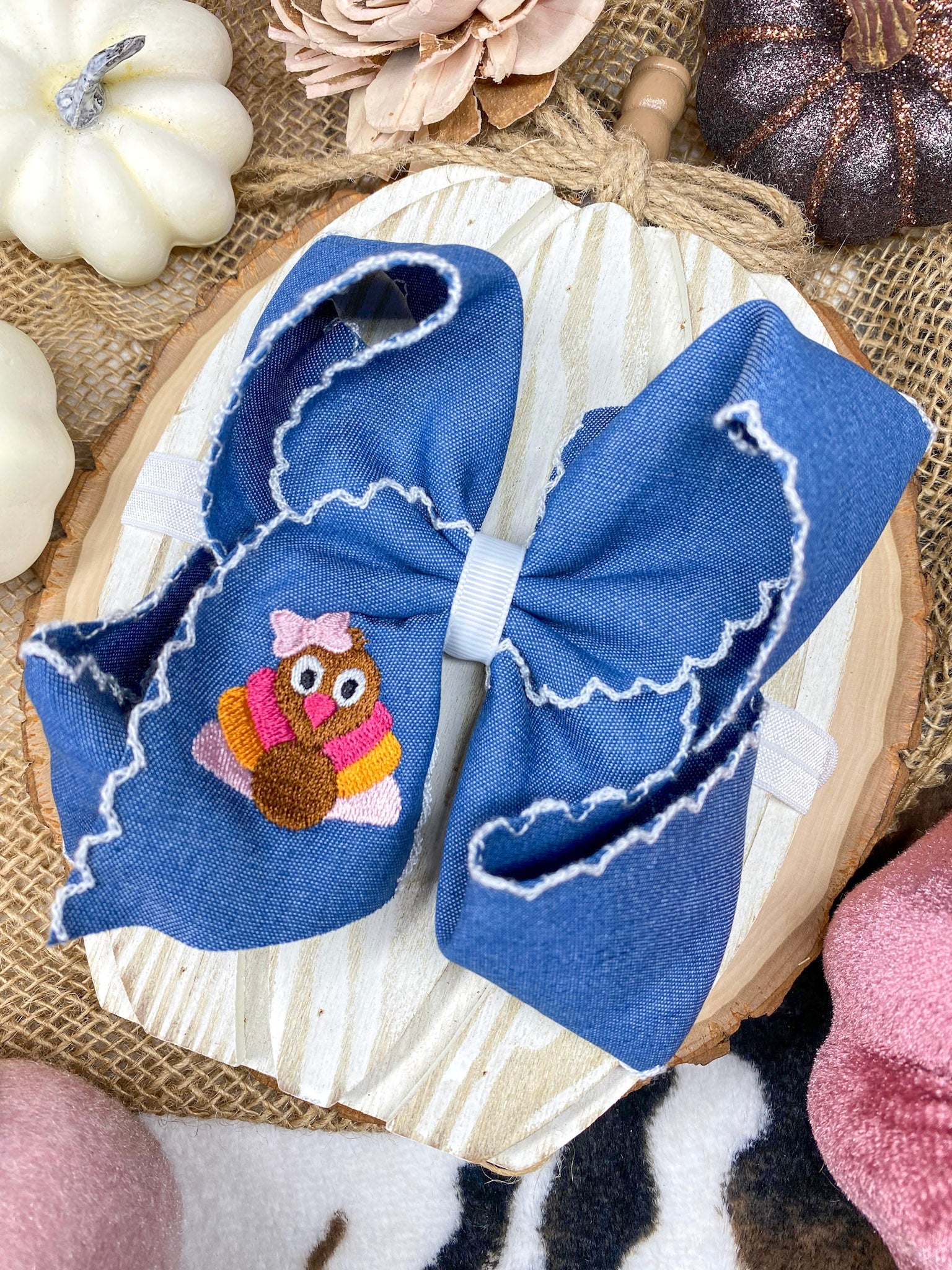 Pink Turkey Moonstitch Headband on Denim Hair Bow on a wooden background