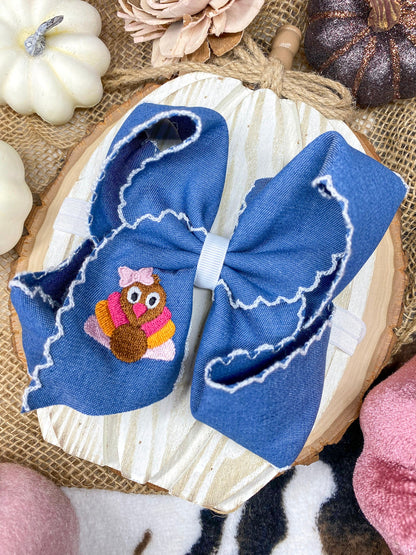 Pink Turkey Moonstitch Headband on Denim Hair Bow on a wooden background