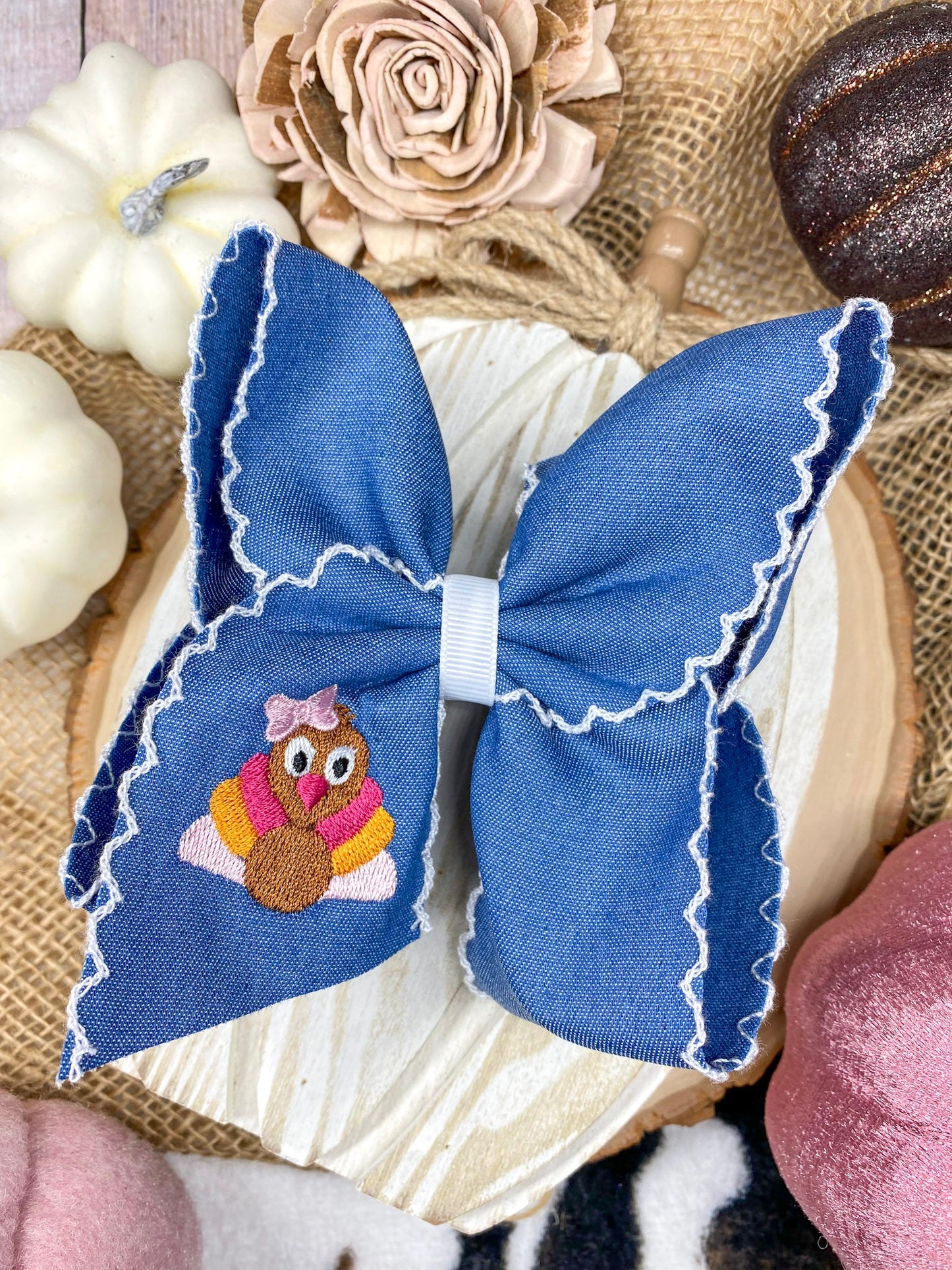 Pink Turkey Moonstitch on Denim Hair Bow on a wooden background
