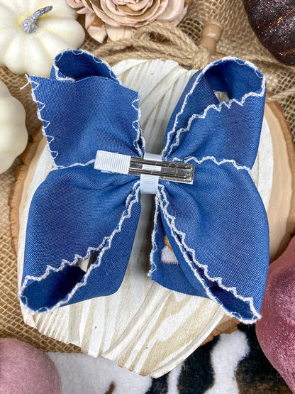 Pink Turkey Moonstitch on Denim Hair Bow on a wooden background