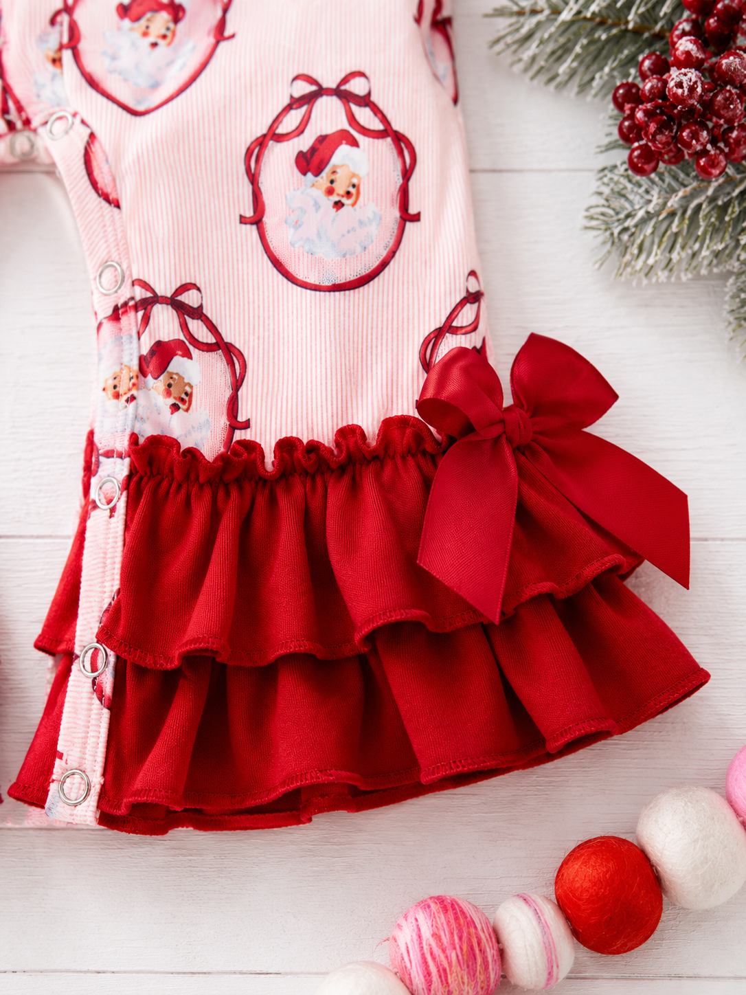 zoomed image of pink santa infant romper fabric