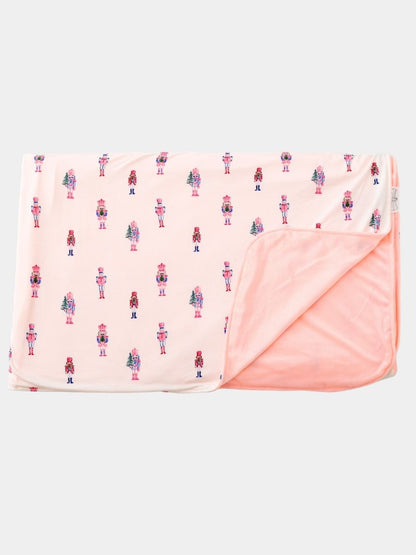 Pink Nutcracker Christmas minky baby blanket featuring a pastel nutcracker print with ultra-soft blush plush minky backing.