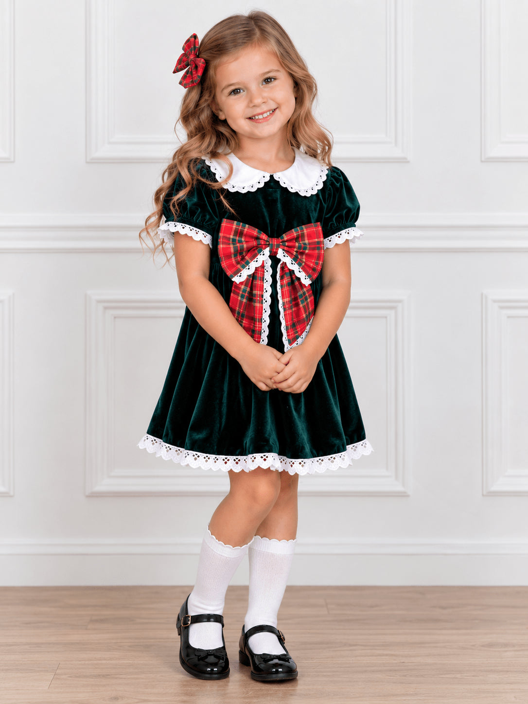 Green velvet girls dress with a plaid bow and lace trim