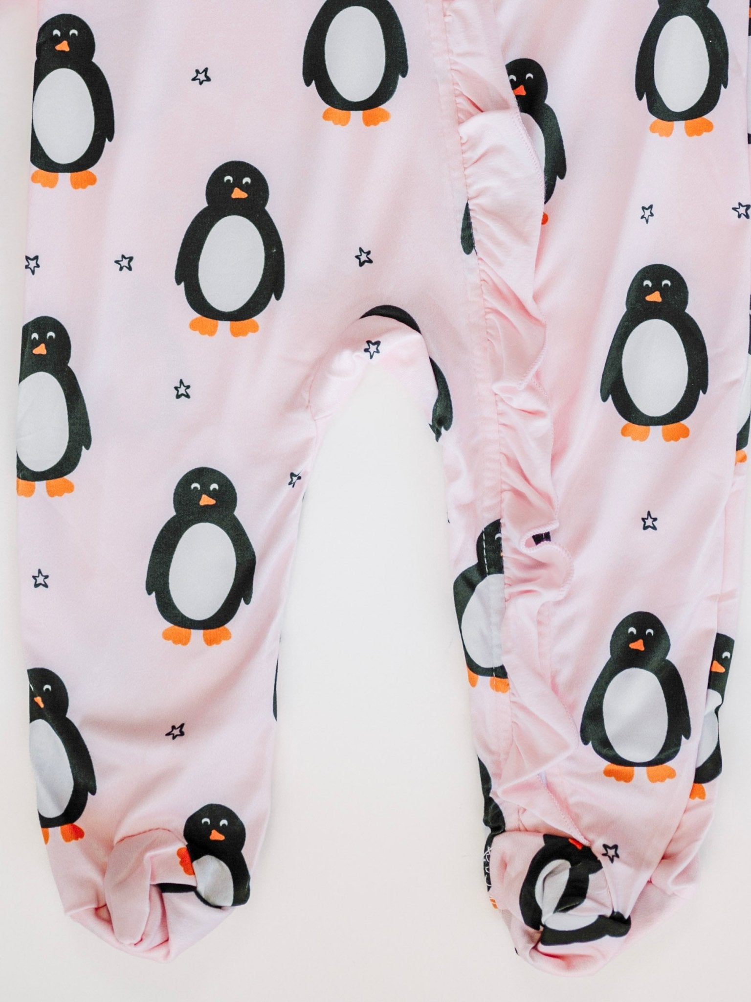 Baby leggings with penguin pattern on a pink background
