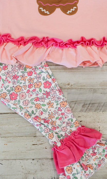 close up of the leggings with floral pattern and flared ruffles at end of pant leg