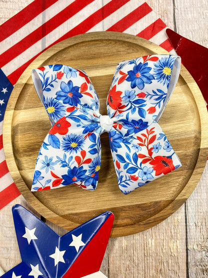 Red White & Blue Floral hairbow on a wooden background
