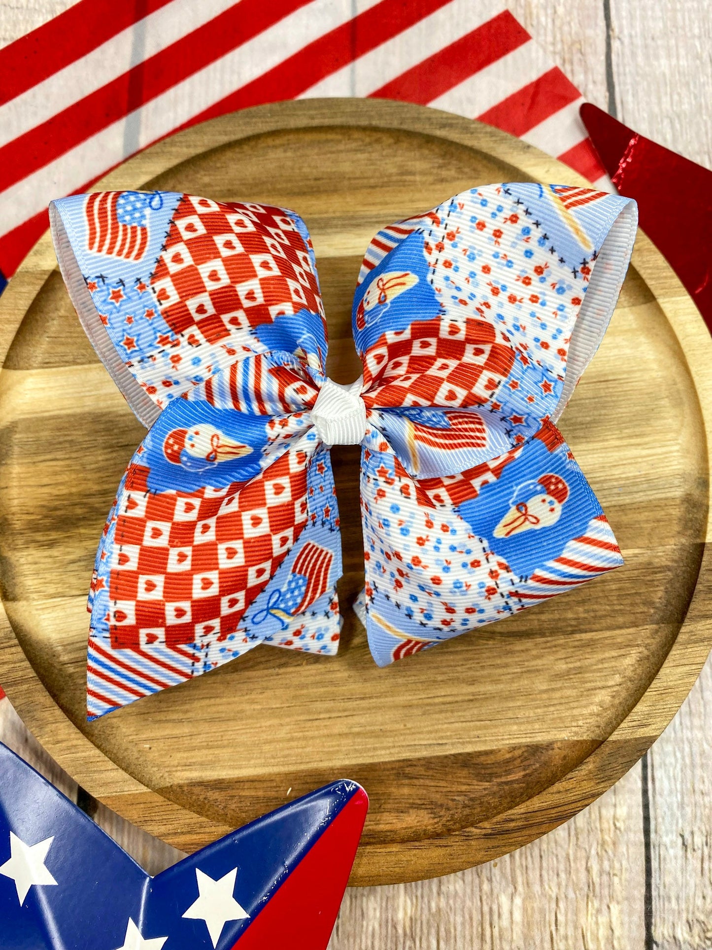 Red White & Blue Patchwork hairbow on a wooden surface