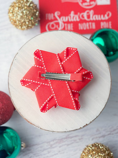 Back of red with white stitch gift hair bow showing alligator clip