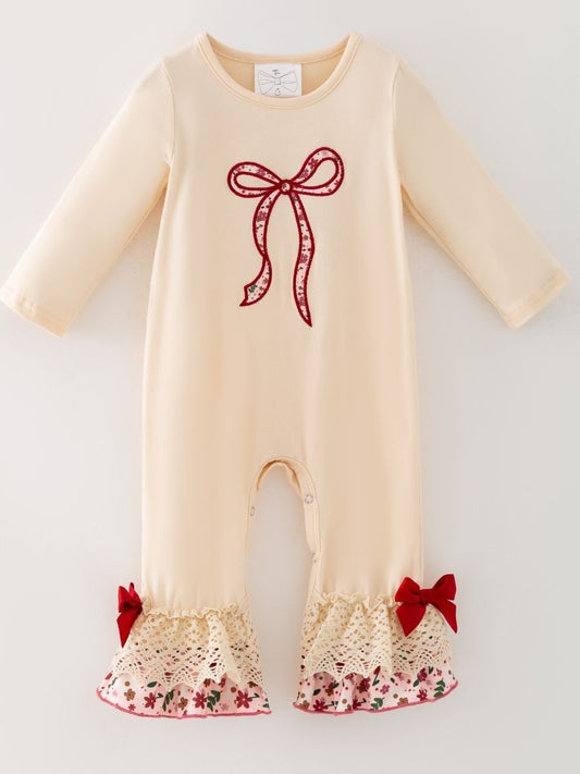 baby girl one-piece with floral bow appliqué, lace ruffle hems, and red velvet bow accents