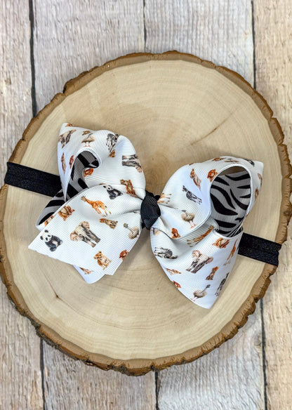 Safari zoo animal print bow headband on a wooden surface