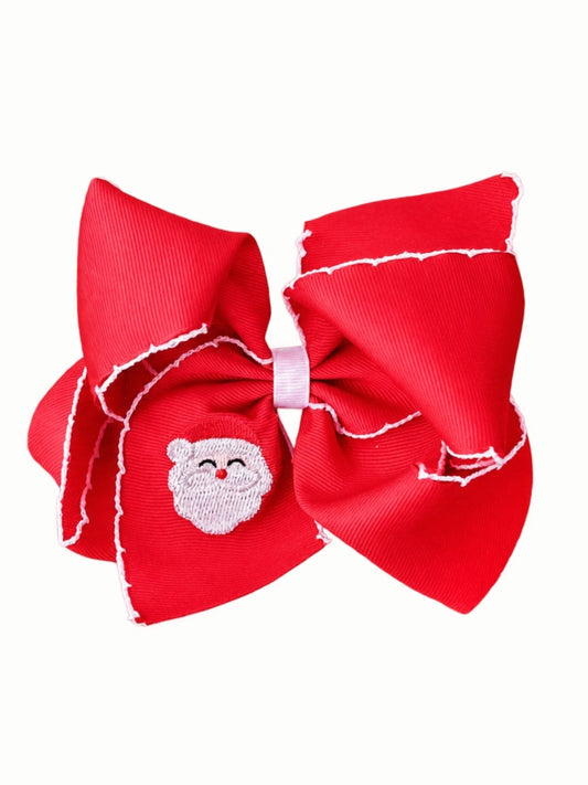 Red moonstitch hair bow with white stitched edges and an embroidered Santa face on the tail, on a white background