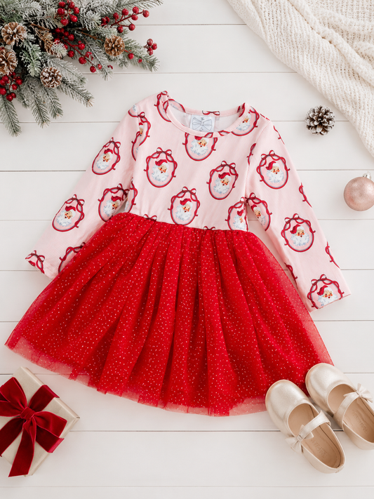 Girls Vintage Santa Christmas tutu dress styled in a festive holiday flatlay with a classic Santa print, glitter red tulle skirt, and coordinating Christmas accessories.