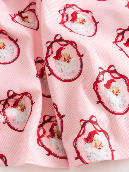 Close-up of pink vintage Santa Christmas fabric featuring classic Santa portrait print on soft striped fabric, highlighting the premium holiday design.