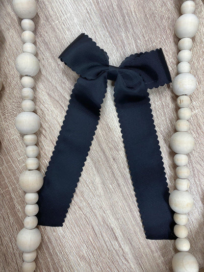 Black scalloped long tail hair bow on alligator clip
