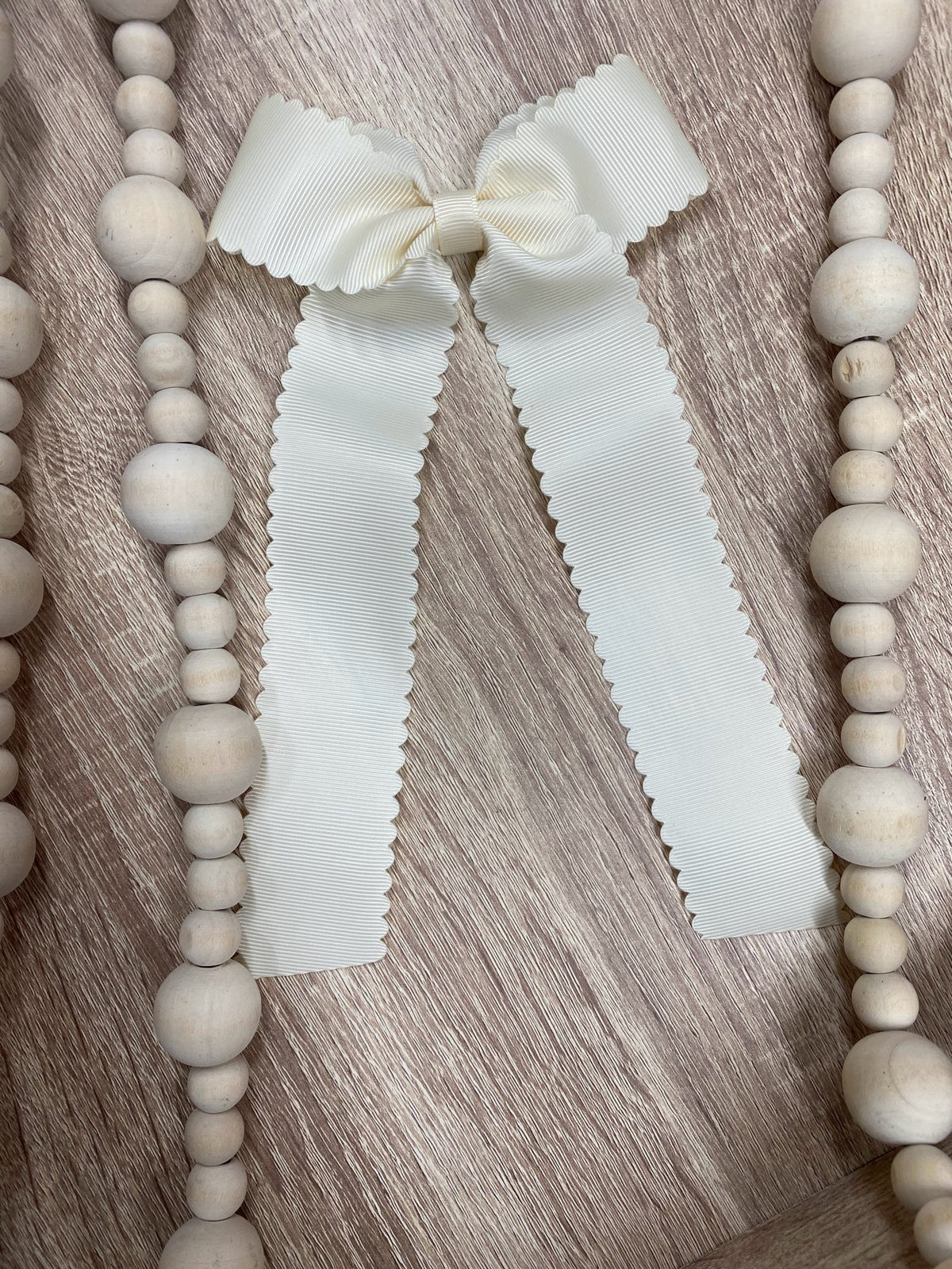 Ivory scalloped long tail hair bow on alligator clip