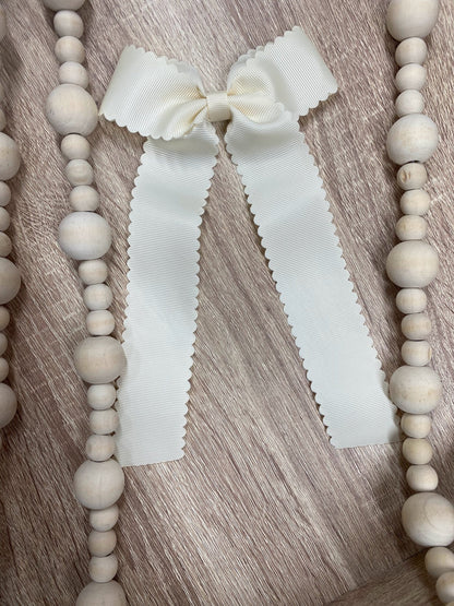 Ivory scalloped long tail hair bow on alligator clip