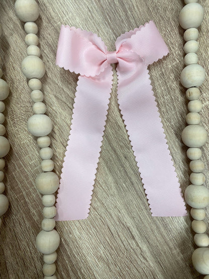 Light pink scalloped long tail hair bow on alligator clip