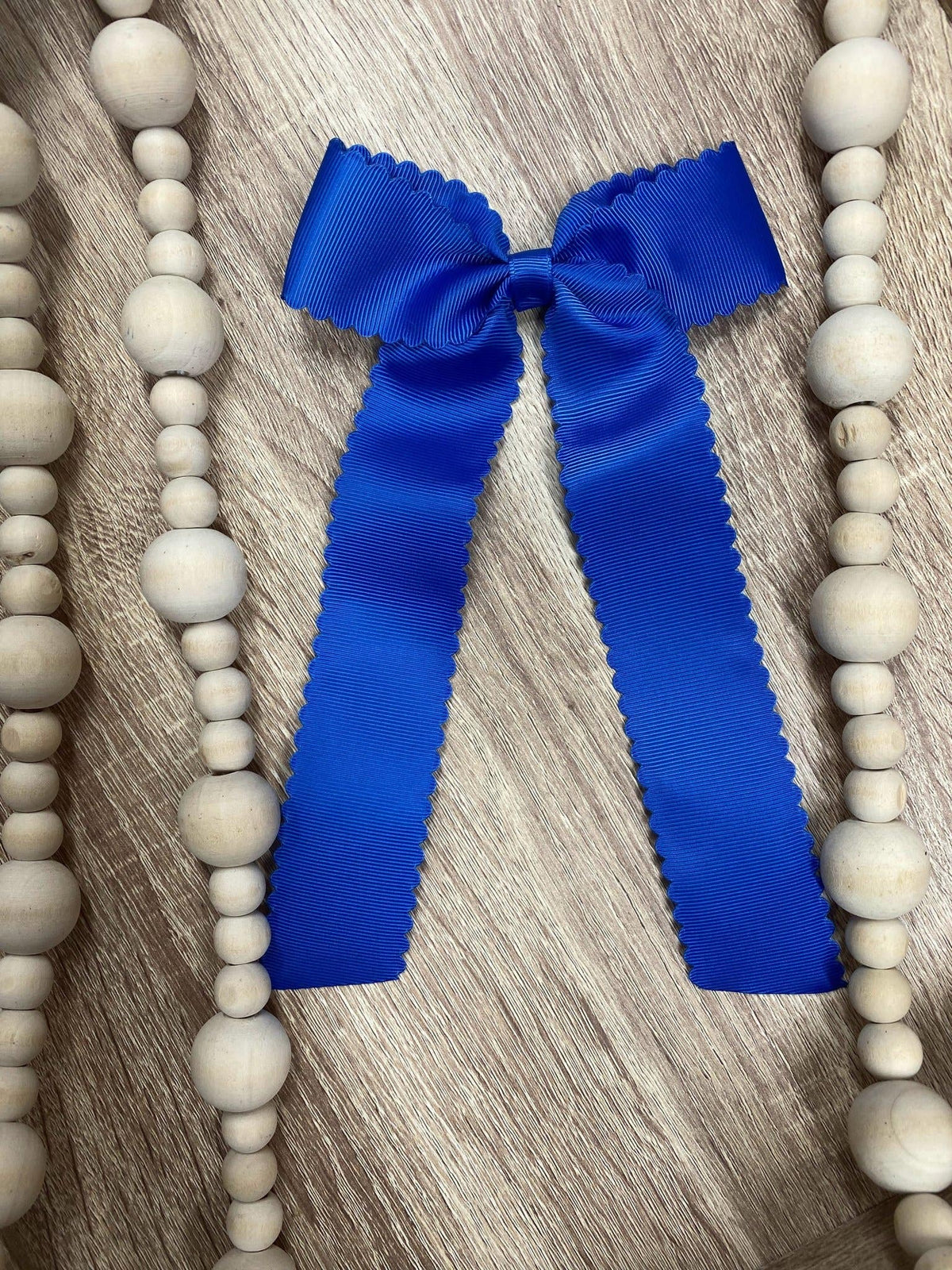 Royal blue scalloped long tail hair bow on alligator clip