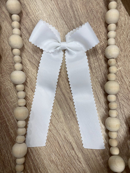 White scalloped long tail hair bow on alligator clip