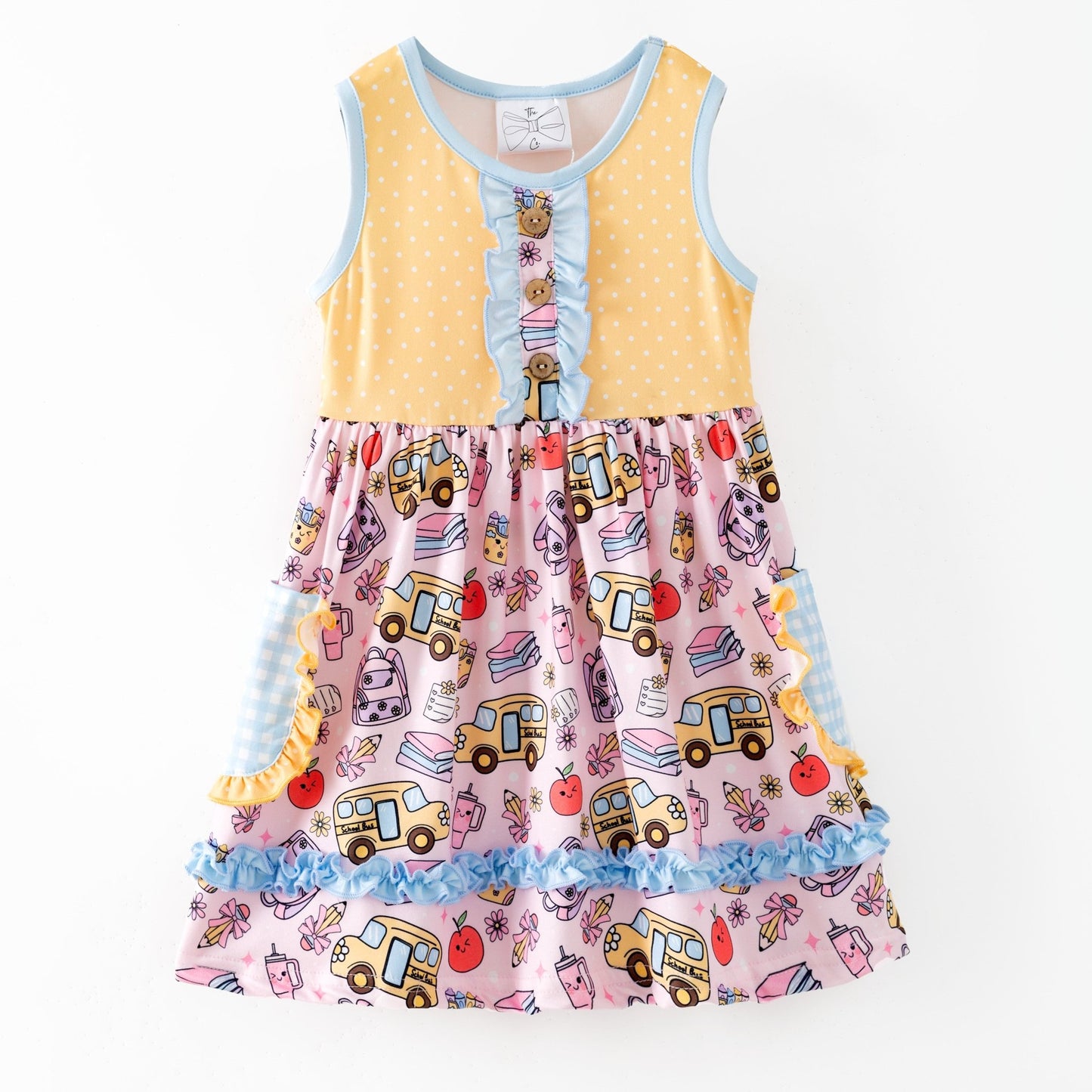 Colorful children's dress with cartoon bus and apple pattern on a white background