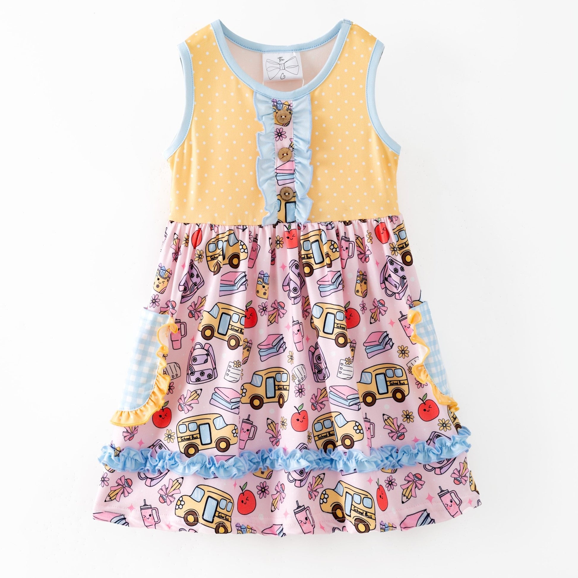 Colorful children's dress with cartoon bus and apple pattern on a white background