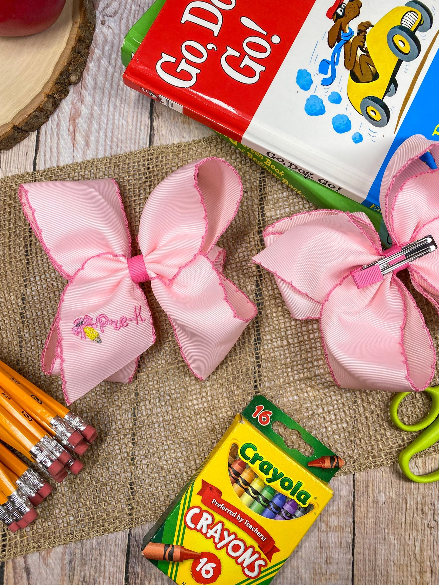 Pink School Grade Embroidered Cheer Bow on a wooden background