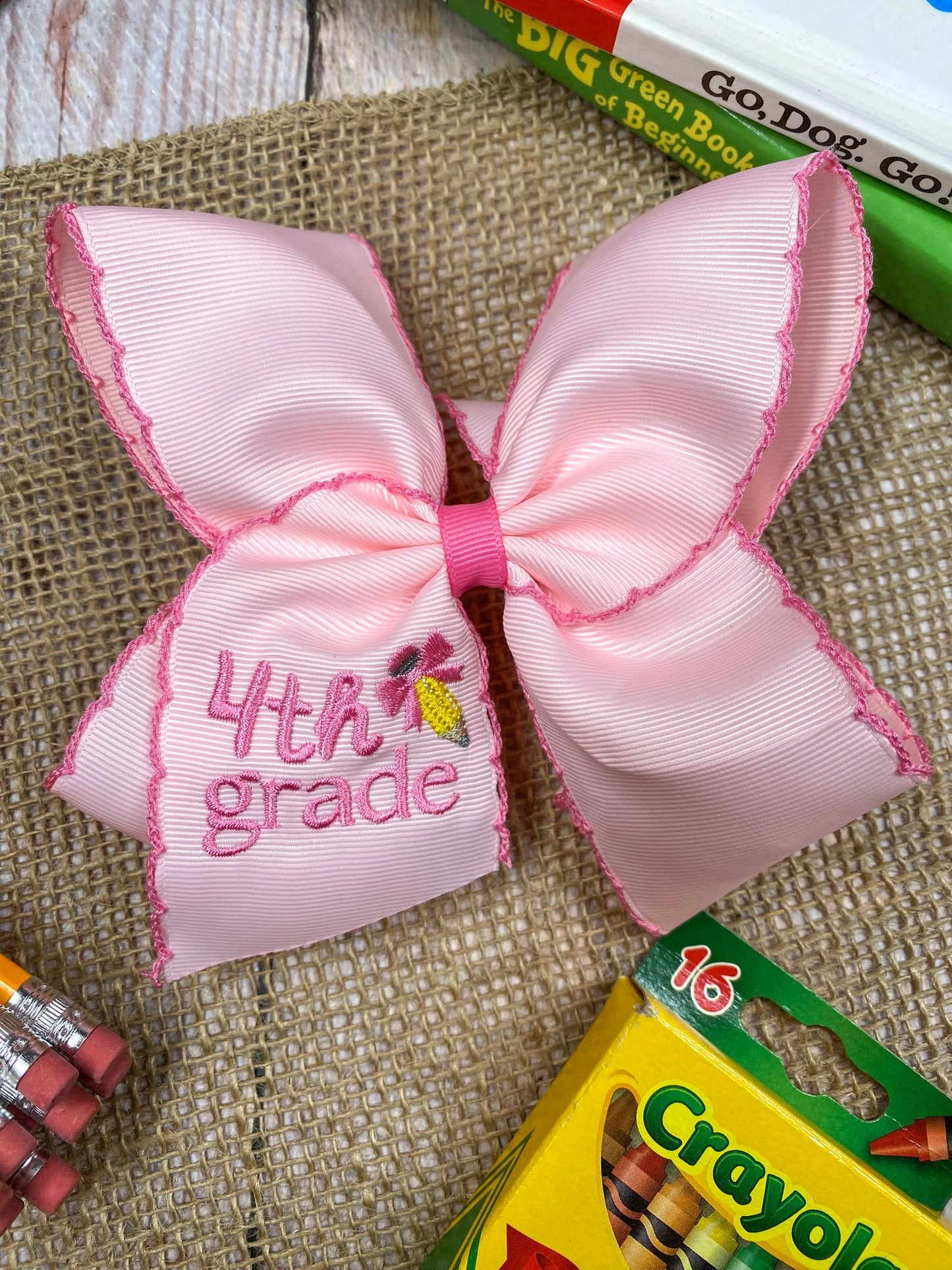 Pink School Grade Embroidered Cheer Bow on a wooden background