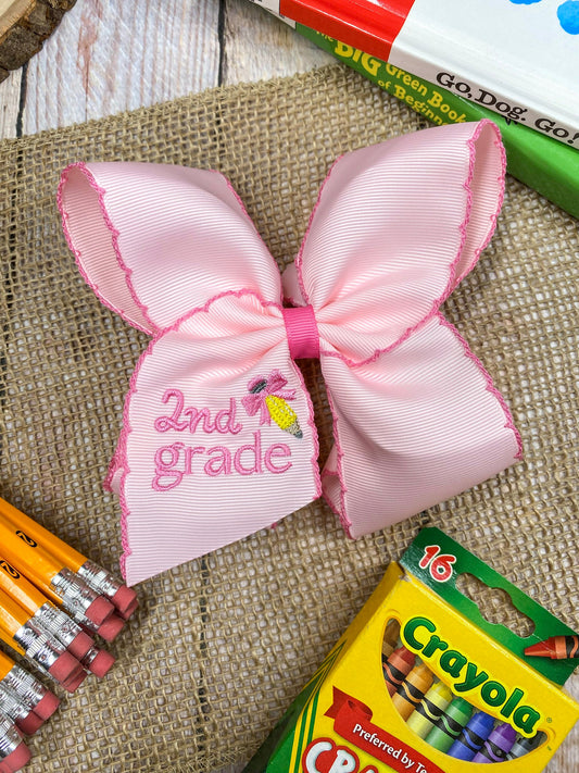 Pink School Grade Embroidered Cheer Bow on a wooden background