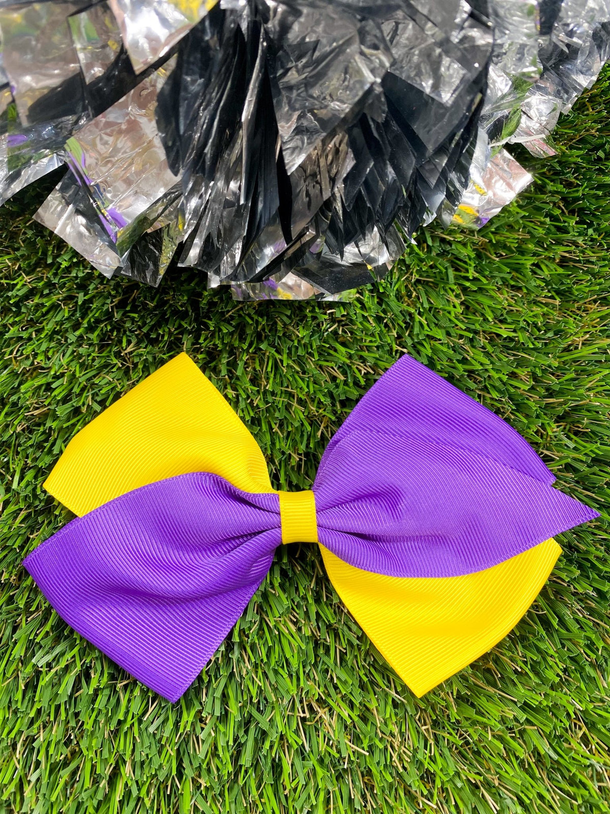 Purple and yellow oversized school spirit hair bow