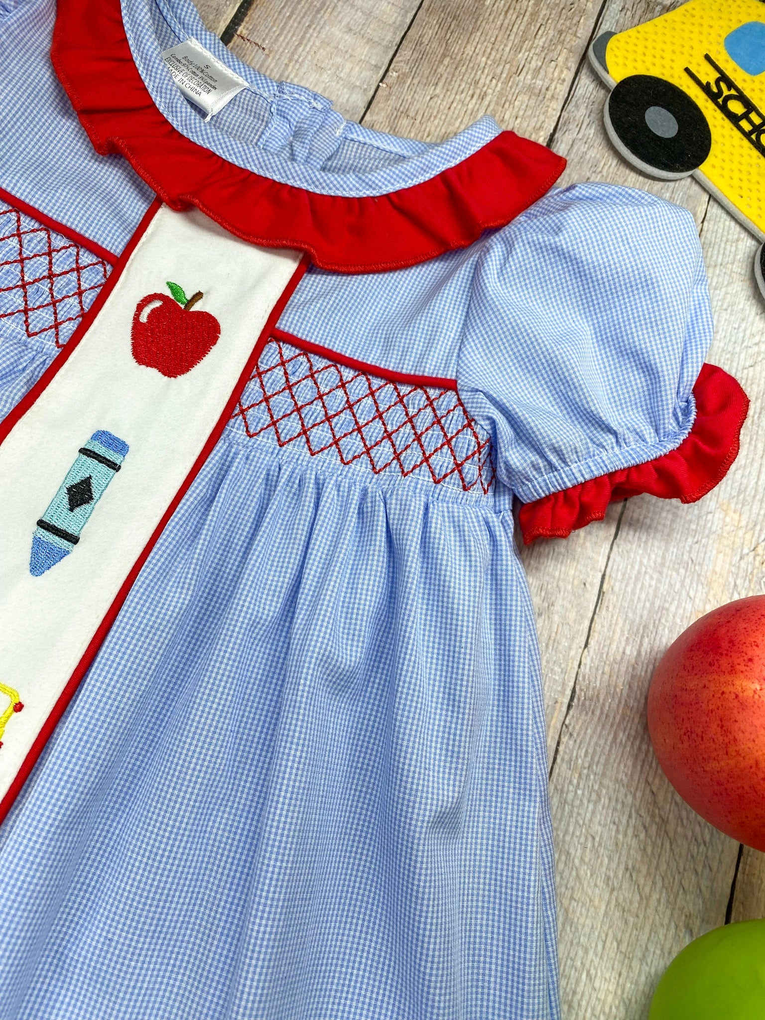 zoom detail of neck, and embroidery on back to school dress