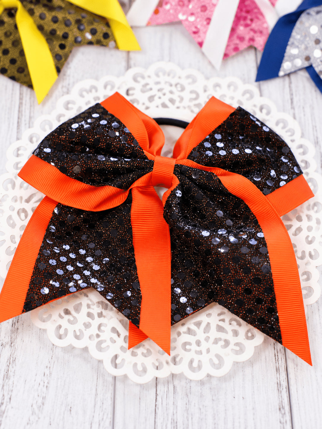 Black and orange sequin school spirit cheer bow on pony-o