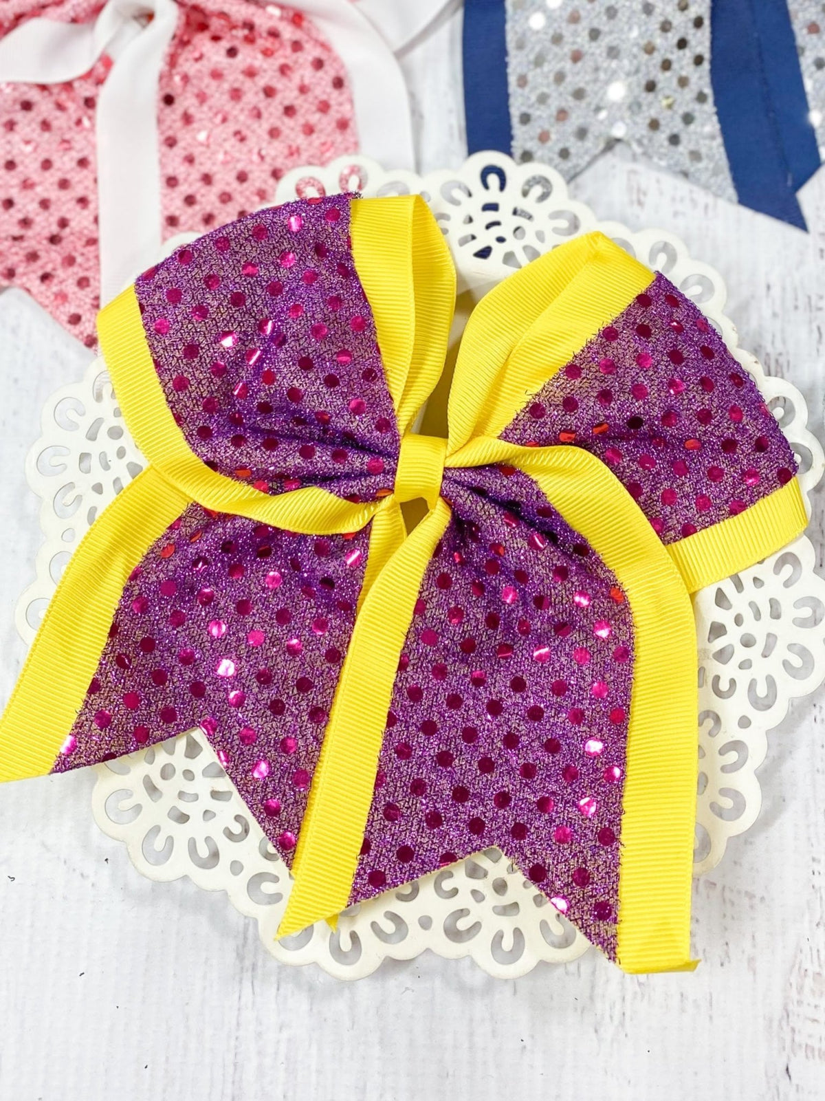 Hot pink and yellow sequin school spirit cheer bow on pony-o