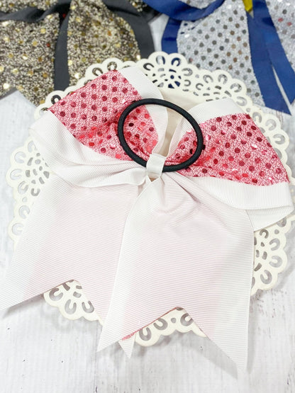 Pink and white sequin cheer bow on a black pony-o
