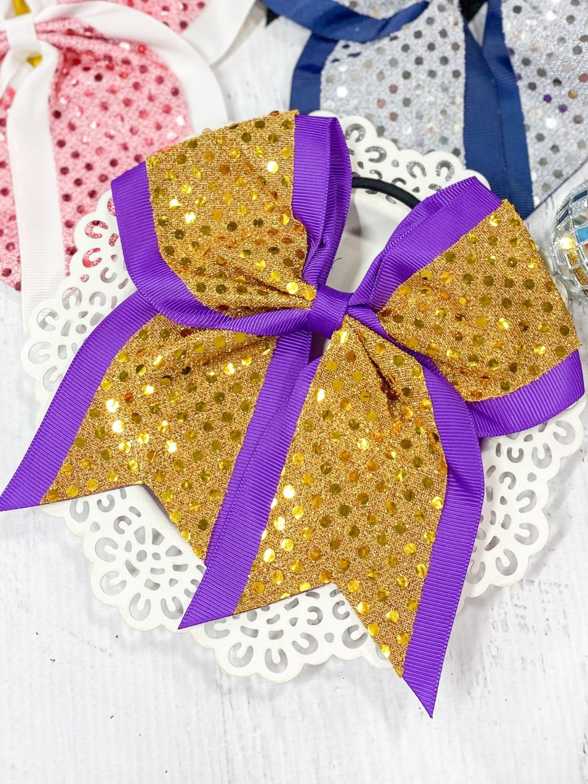 Yellow and purple sequin school spirit cheer bow on pony-o