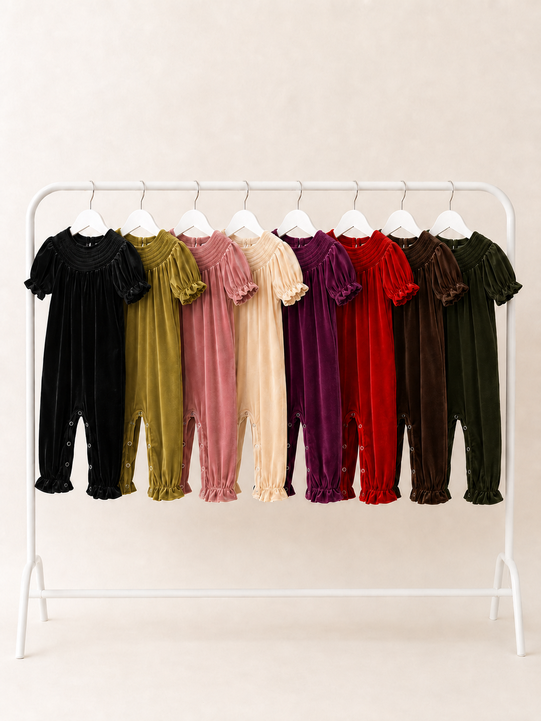 girls smocked velvet holiday rompers in 8 colors on clothing rack
