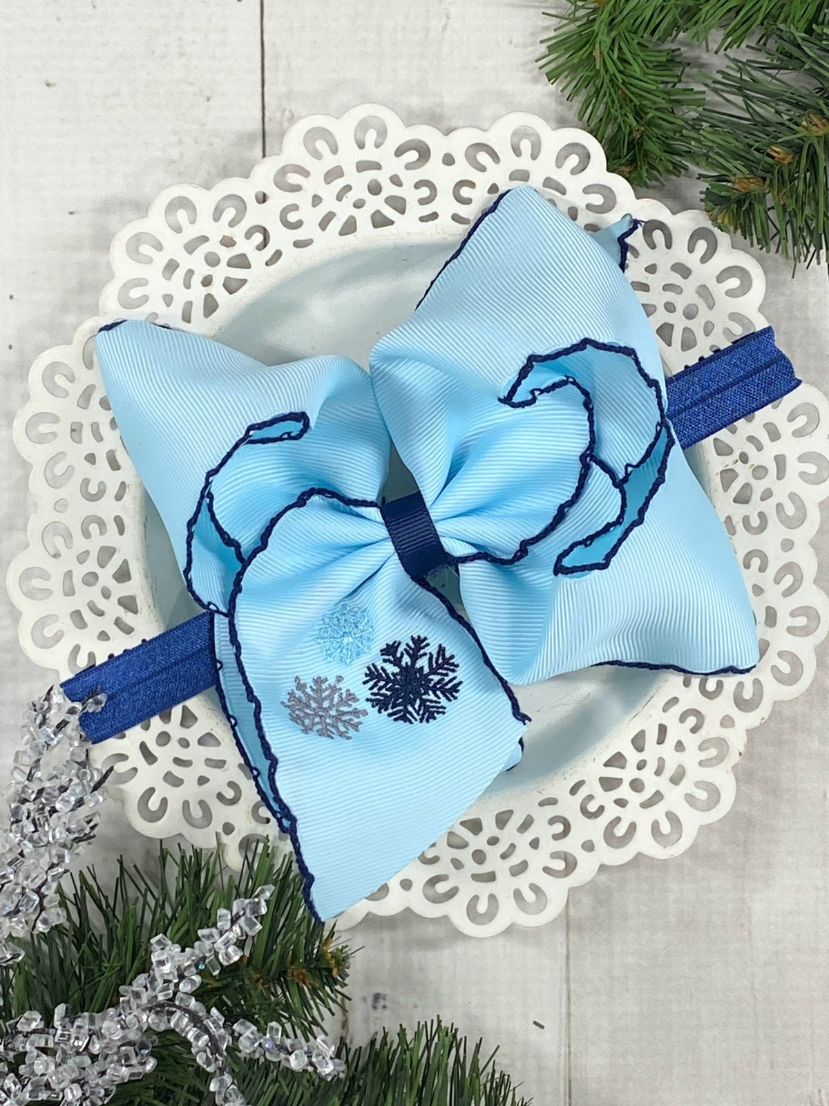 Snowflake embroidered moonstitch bow on satin headband