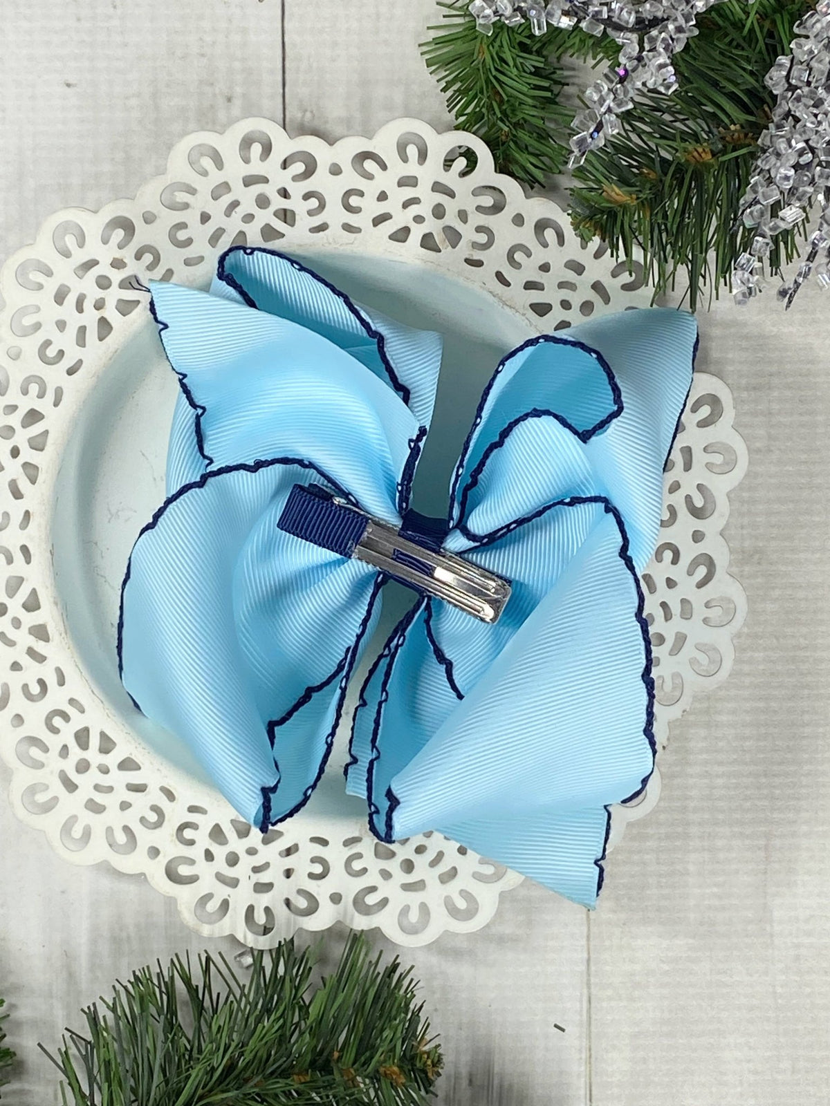 Back of snowflake embroidered moonstitch hair bow showing alligator clip