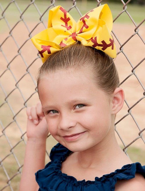Girl wearing a softball Texas size hair bow