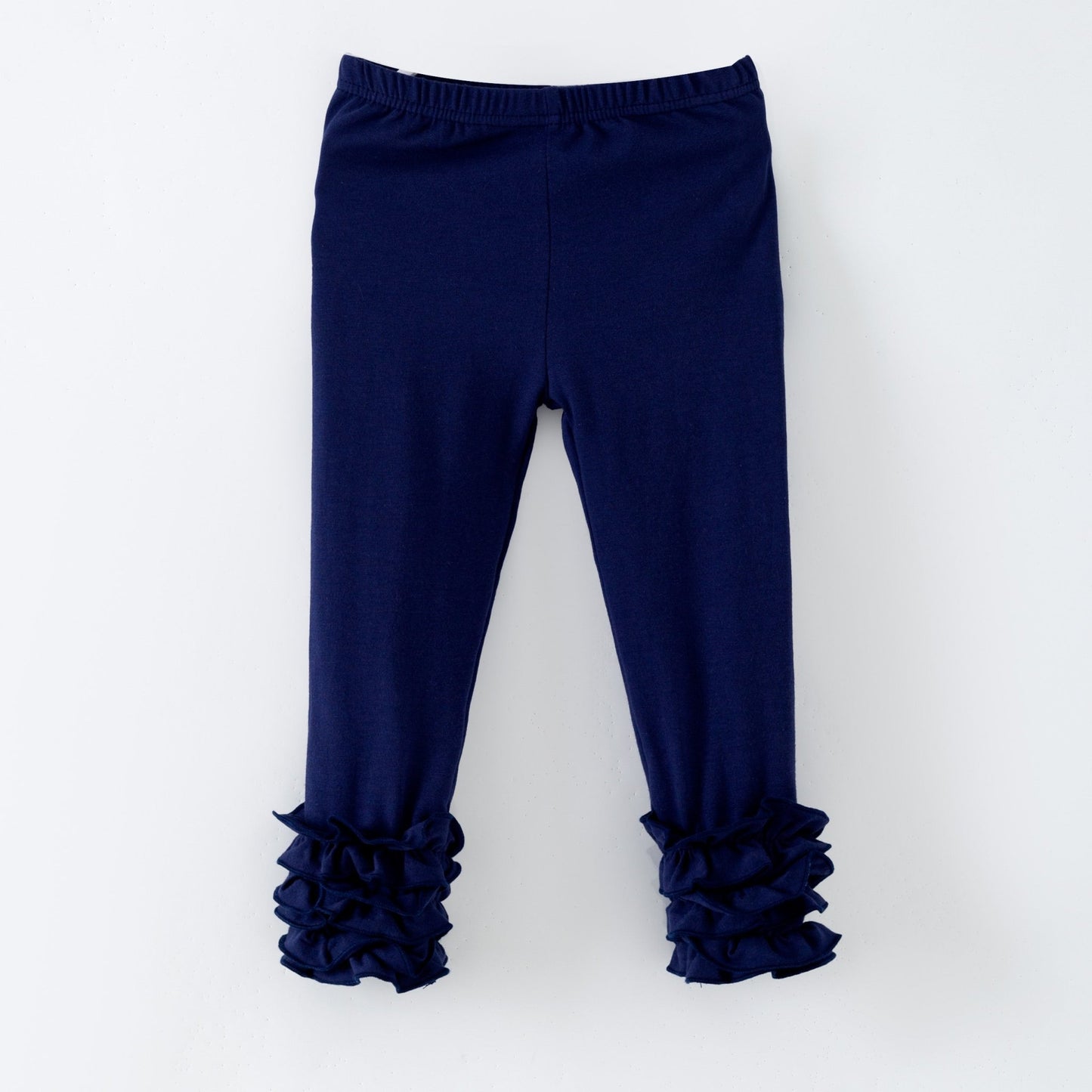 Navy blue leggings with ruffled cuffs on a white background