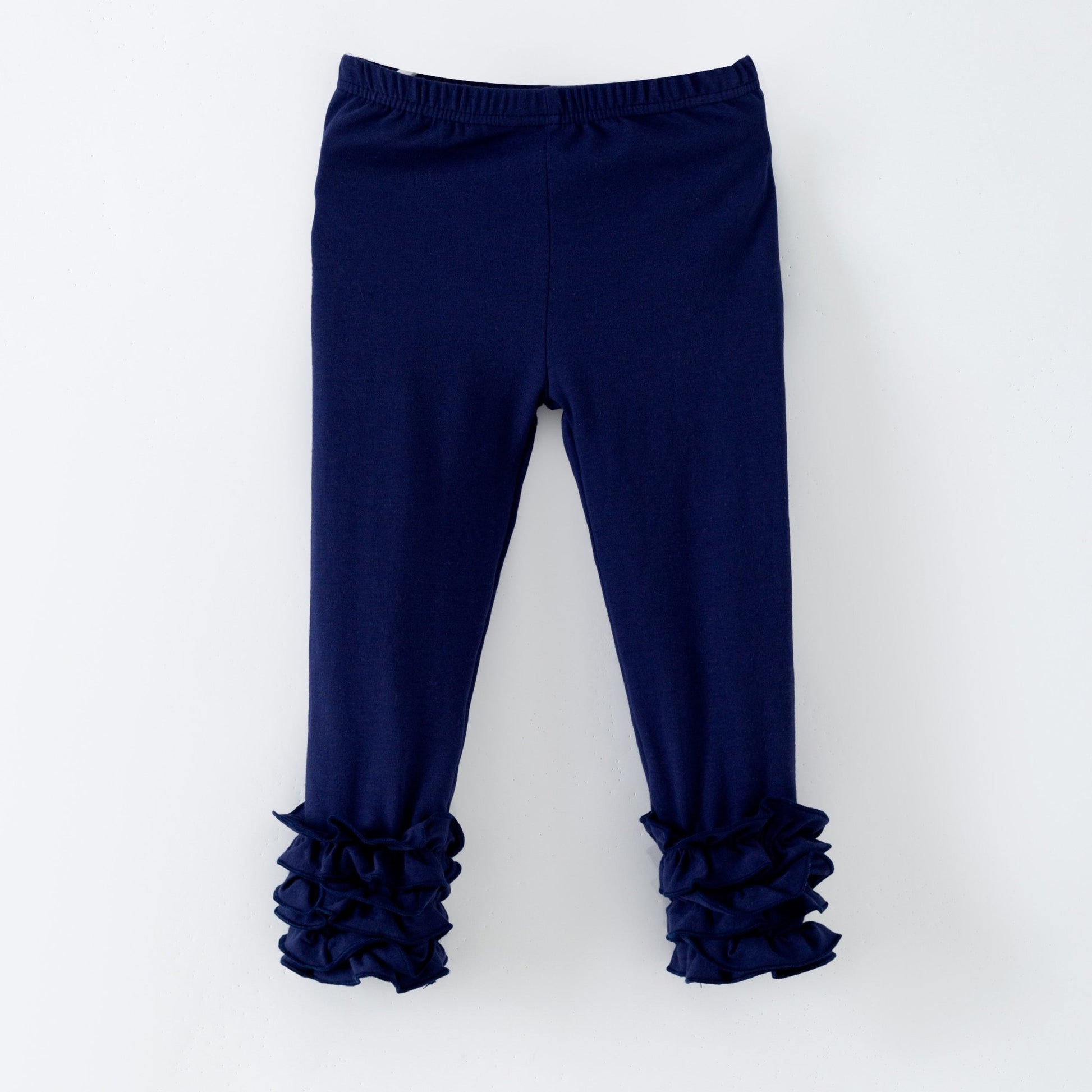 Navy blue leggings with ruffled cuffs on a white background